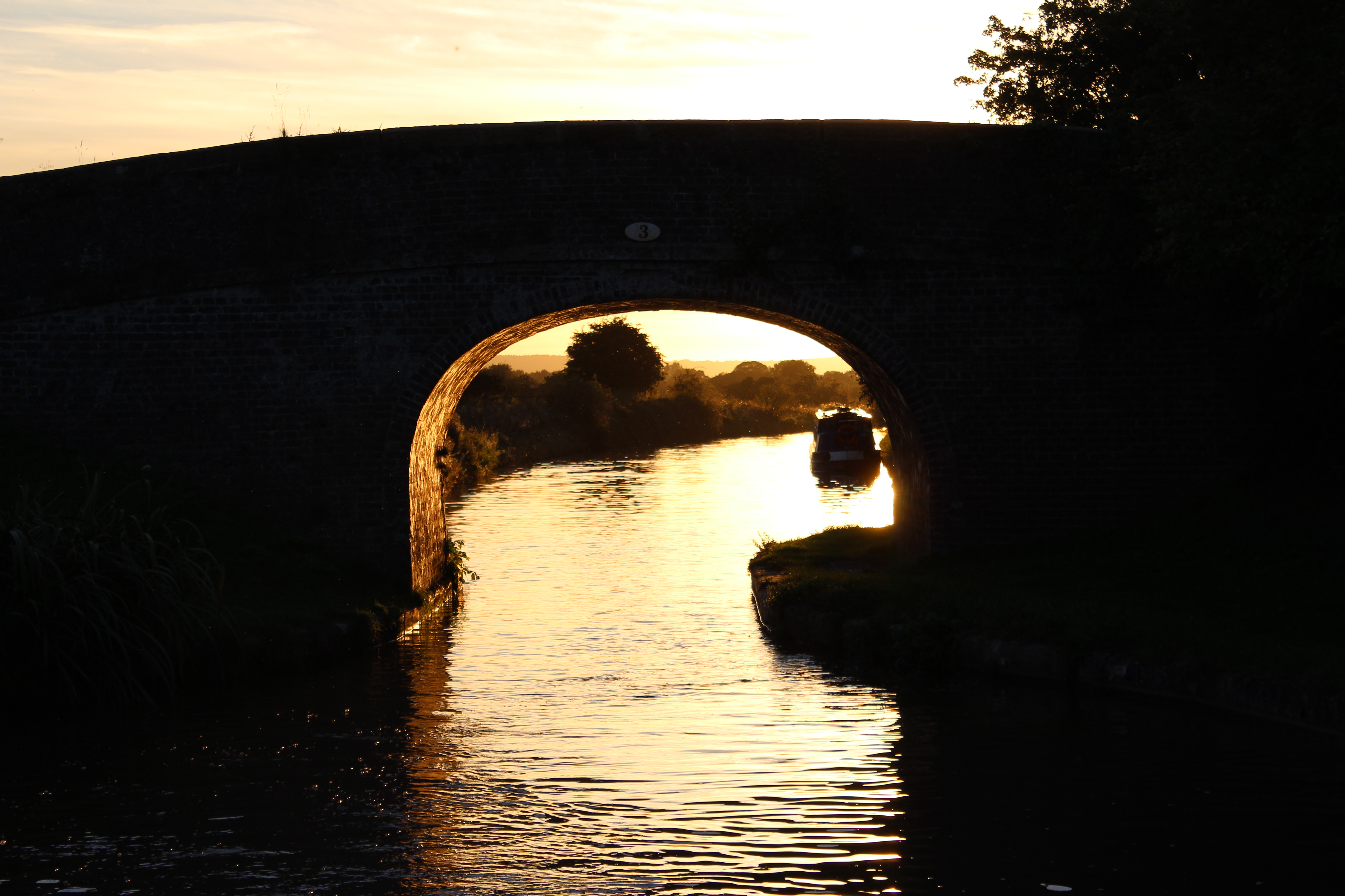 The setting sun behind a classic Middlewich Branch Bridge